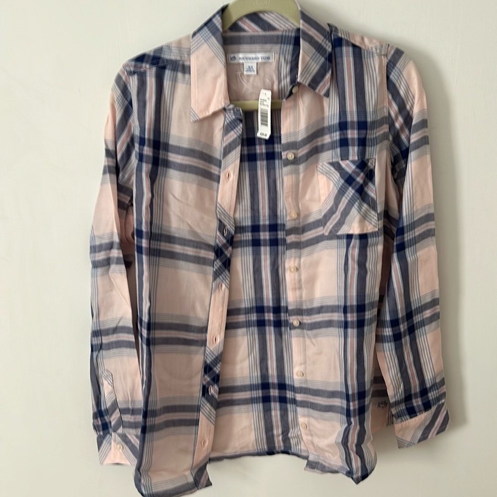 Plaid button down shirt.